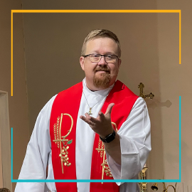 Bishop Jonathan Smith wearing white robes and red vestment.